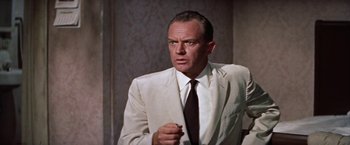 Movie still from “Some Came Running” (1958), directed by Vincente Minnelli – An older man wearing a white suit and tie; Close Up shot, Low angle