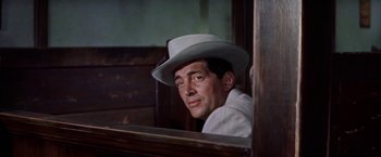 Movie still from “Some Came Running” (1958), directed by Vincente Minnelli – A man wearing a white hat looking out of a window; Close Up shot, Low angle