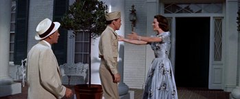 Movie still from “Some Came Running” (1958), directed by Vincente Minnelli – A man and a woman dressed in formal clothes; Medium shot, Low angle