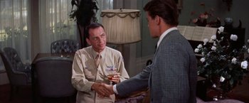 Movie still from “Some Came Running” (1958), directed by Vincente Minnelli – Two men shake hands over a glass of beer; Medium shot, Over the shoulder angle