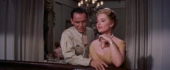 Movie still from “Some Came Running” (1958), directed by Vincente Minnelli – A man and a woman sitting at a bar; Medium shot, Low angle
