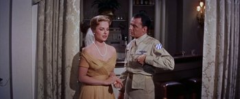 Movie still from “Some Came Running” (1958), directed by Vincente Minnelli – A man and a woman standing next to each other in a room; Medium shot, Low angle
