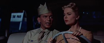 Movie still from “Some Came Running” (1958), directed by Vincente Minnelli – A man and a woman sitting next to each other in a car; Close Up shot, Low angle