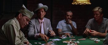 Movie still from “Some Came Running” (1958), directed by Vincente Minnelli – Two men sitting at a table playing a game of poker; Medium shot, Over the shoulder angle