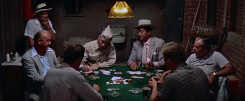 Movie still from “Some Came Running” (1958), directed by Vincente Minnelli – A group of men sitting around a table playing cards; Medium shot, High angle