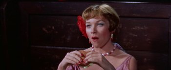 Movie still from “Some Came Running” (1958), directed by Vincente Minnelli – A woman holding a hamburger in her hands; Close Up shot, High angle