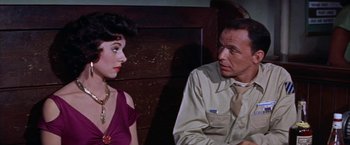 Movie still from “Some Came Running” (1958), directed by Vincente Minnelli – A man and a woman sitting next to each other on a bench; Close Up shot, Over the shoulder angle