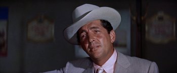 Movie still from “Some Came Running” (1958), directed by Vincente Minnelli – A person wearing a suit and a hat; Close Up shot, Low angle