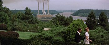 Movie still from “Some Came Running” (1958), directed by Vincente Minnelli – A view of trees and a power plant from a distance; Extreme Wide shot, High angle