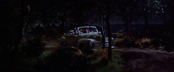 Movie still from “Some Came Running” (1958), directed by Vincente Minnelli – An old car parked in the middle of a field; Extreme Wide shot, High angle