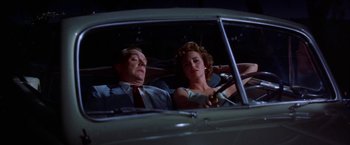 Movie still from “Some Came Running” (1958), directed by Vincente Minnelli – A man and a woman in the back seat of a car; Medium shot, Low angle