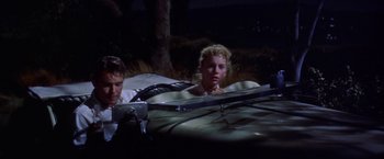 Movie still from “Some Came Running” (1958), directed by Vincente Minnelli – A man and a woman sitting next to each other in a car; Medium shot, Low angle