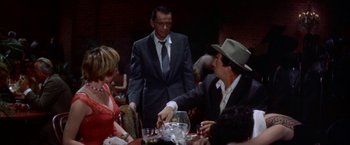 Movie still from “Some Came Running” (1958), directed by Vincente Minnelli – A group of people sitting at a table with food; Medium shot, Over the shoulder angle