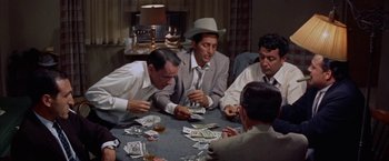 Movie still from “Some Came Running” (1958), directed by Vincente Minnelli – A group of men sitting at a table playing cards; Medium shot, High angle