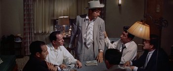 Movie still from “Some Came Running” (1958), directed by Vincente Minnelli – A group of men sitting around a table; Medium shot, Over the shoulder angle