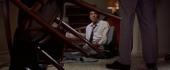 Movie still from “Some Came Running” (1958), directed by Vincente Minnelli – A man sitting on the ground in a room; Medium shot, High angle