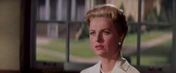 Movie still from “Some Came Running” (1958), directed by Vincente Minnelli – A woman that is wearing a white shirt; Close Up shot, Low angle