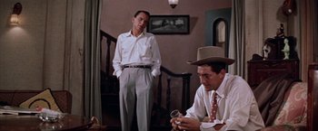 Movie still from “Some Came Running” (1958), directed by Vincente Minnelli – Two men standing next to each other in front of a staircase; Medium shot, Low angle