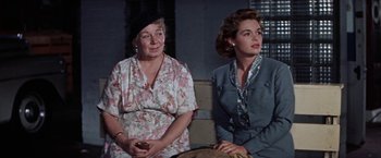 Movie still from “Some Came Running” (1958), directed by Vincente Minnelli – Two women sitting next to each other in a room; Medium shot, Low angle