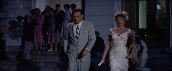 Movie still from “Some Came Running” (1958), directed by Vincente Minnelli – A man and a woman walking down the stairs; Medium shot, Low angle