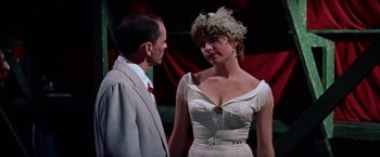 Movie still from “Some Came Running” (1958), directed by Vincente Minnelli – A man and a woman standing next to each other; Medium shot, Over the shoulder angle