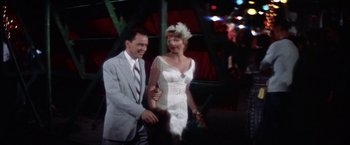 Movie still from “Some Came Running” (1958), directed by Vincente Minnelli – A man and a woman are walking together; Medium shot, High angle