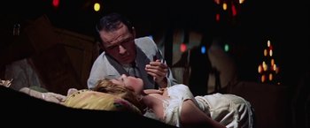 Movie still from “Some Came Running” (1958), directed by Vincente Minnelli – An old man and a young woman are in a room; Medium shot, Low angle