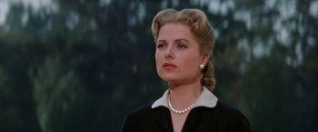 Movie still from “Some Came Running” (1958), directed by Vincente Minnelli – A woman in a black dress and a pearl necklace; Close Up shot, Low angle