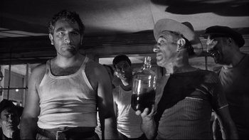 Movie still from “Somebody Up There Likes Me” (1956), directed by Robert Wise – A group of men standing next to each other holding a bottle; Medium shot, Low angle