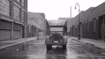 Movie still from “Somebody Up There Likes Me” (1956), directed by Robert Wise – An old photo of an oakland bus driving down the street; Extreme Wide shot, Low angle
