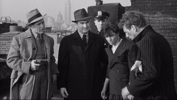 Movie still from “Somebody Up There Likes Me” (1956), directed by Robert Wise – A group of men standing next to each other on a bridge; Medium shot, Low angle
