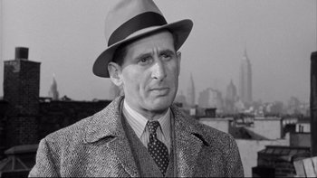 Movie still from “Somebody Up There Likes Me” (1956), directed by Robert Wise – A man wearing a hat and a suit; Close Up shot, Low angle