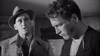 Movie still from “Somebody Up There Likes Me” (1956), directed by Robert Wise – Two men in suits and hats looking at each other; Close Up shot, Low angle