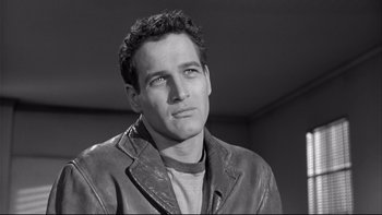 Movie still from “Somebody Up There Likes Me” (1956), directed by Robert Wise – Black and white photograph of a man wearing a leather jacket; Close Up shot, Low angle