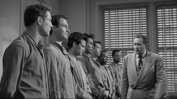 Movie still from “Somebody Up There Likes Me” (1956), directed by Robert Wise – Black and white photograph of a group of young men in suits; Medium shot, Low angle