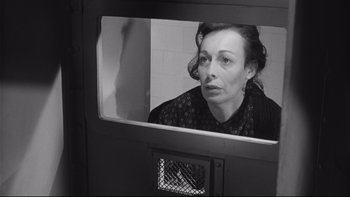 Movie still from “Somebody Up There Likes Me” (1956), directed by Robert Wise – A black and white photo of a woman looking out of a window; Close Up shot, Low angle