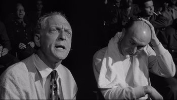 Movie still from “Somebody Up There Likes Me” (1956), directed by Robert Wise – Two men are sitting next to each other; Medium shot, Low angle