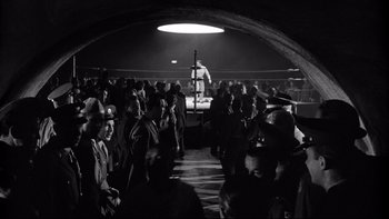 Movie still from “Somebody Up There Likes Me” (1956), directed by Robert Wise – A crowd of people watching a boxing match; Wide shot, High angle