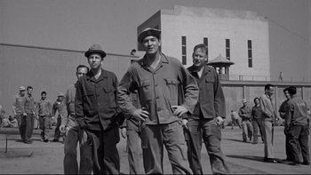 Movie still from “Somebody Up There Likes Me” (1956), directed by Robert Wise – Black and white photograph of a group of men standing together; Wide shot, Low angle