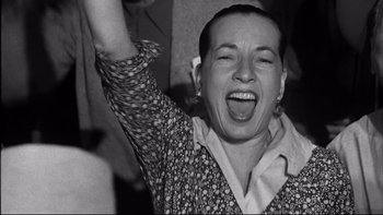 Movie still from “Somebody Up There Likes Me” (1956), directed by Robert Wise – An old photo of a woman with her mouth wide open; Close Up shot, Low angle