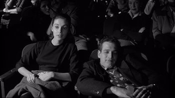 Movie still from “Somebody Up There Likes Me” (1956), directed by Robert Wise – A man and a woman sitting next to each other in a theater; Medium shot, High angle