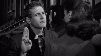 Movie still from “Somebody Up There Likes Me” (1956), directed by Robert Wise – A man is being sworn in by a woman; Close Up shot, Over the shoulder angle