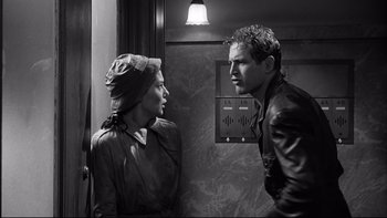 Movie still from “Somebody Up There Likes Me” (1956), directed by Robert Wise – A man and a woman are standing next to each other; Medium shot, Over the shoulder angle