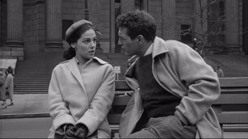 Movie still from “Somebody Up There Likes Me” (1956), directed by Robert Wise – A man and a woman sitting next to each other on a bench; Medium shot, Over the shoulder angle