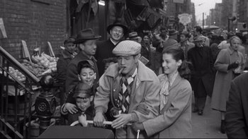 Movie still from “Somebody Up There Likes Me” (1956), directed by Robert Wise – An old black and white photo of a group of people; Medium shot, High angle