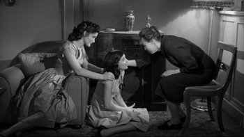 Movie still from “Somebody Up There Likes Me” (1956), directed by Robert Wise – Two women and a little girl sitting on the floor; Medium shot, High angle
