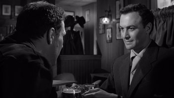 Movie still from “Somebody Up There Likes Me” (1956), directed by Robert Wise – Two men are sitting at a table in a restaurant; Close Up shot, Over the shoulder angle
