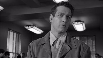 Movie still from “Somebody Up There Likes Me” (1956), directed by Robert Wise – Black and white photograph of a man wearing a suit and tie; Close Up shot, Low angle