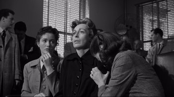 Movie still from “Somebody Up There Likes Me” (1956), directed by Robert Wise – A group of women standing next to each other in front of a window; Medium shot, Low angle