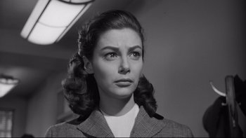 Movie still from “Somebody Up There Likes Me” (1956), directed by Robert Wise – A black and white photo of a woman in a suit; Close Up shot, Low angle